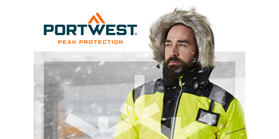 Trabajador barbudo sobre un fondo cubierto de nieve, con una capucha forrada de piel y una chaqueta de invierno amarilla de alta visibilidad.