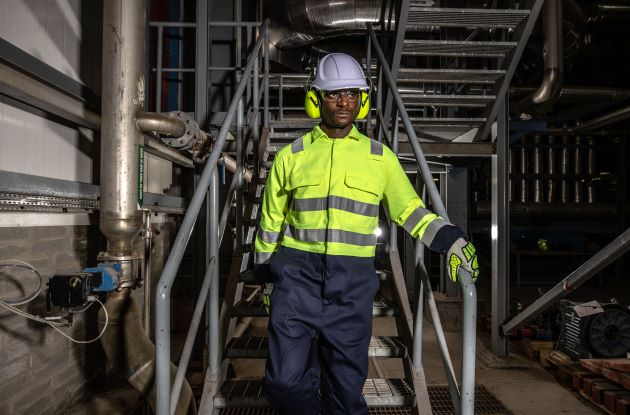 Trabajador con ropa de alta visibilidad bajando un tramo de escaleras